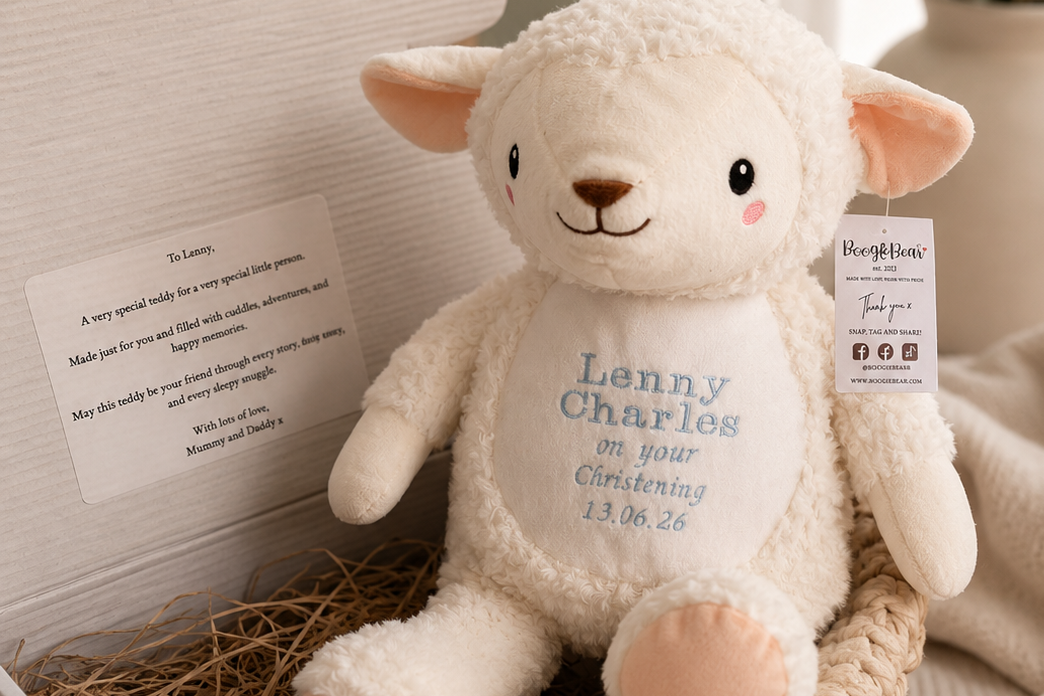 Plush lamb toy with personalized message in a basket, surrounded by soft textures and decor.