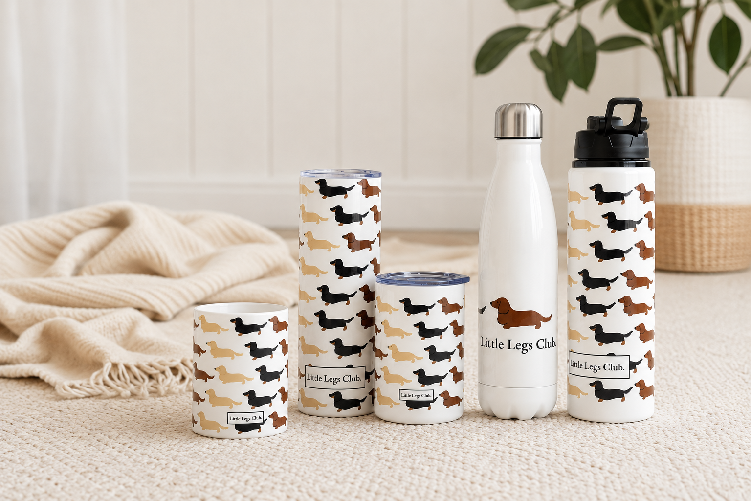 Collection of 'Little Legs Club' branded tumblers and a water bottle on a neutral background.