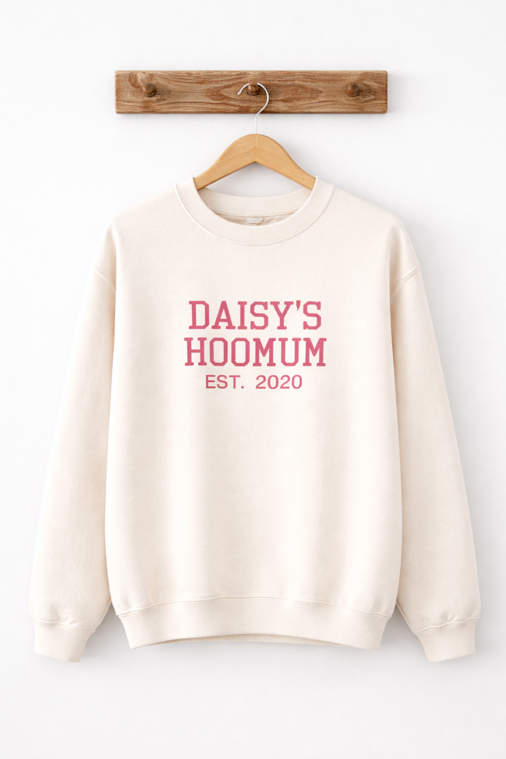 Beige sweatshirt with pink text 'DAISY'S HOOMUM EST. 2020' on a white background