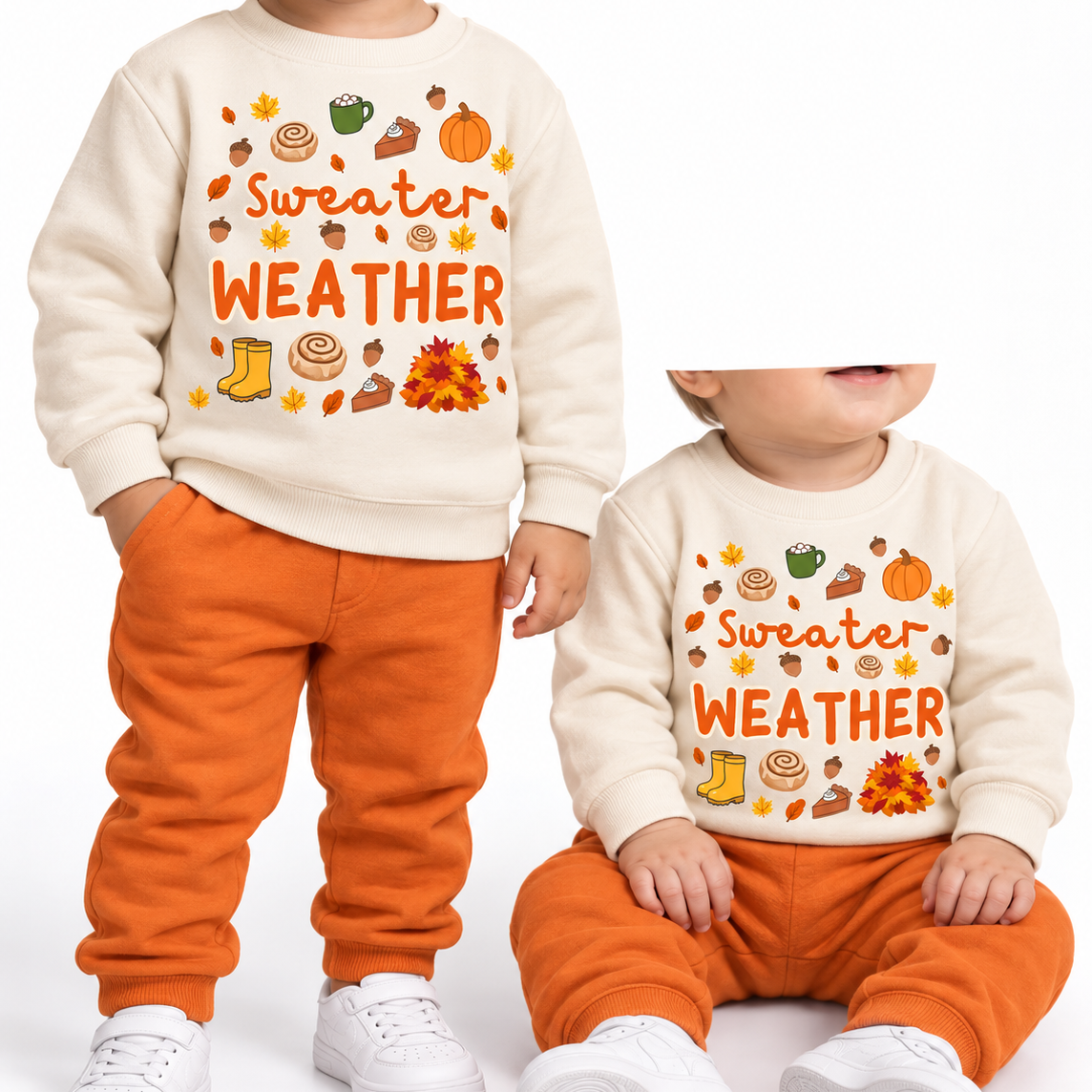 Two toddlers in oatmeal Sweater Weather printed sweatshirts and orange joggers